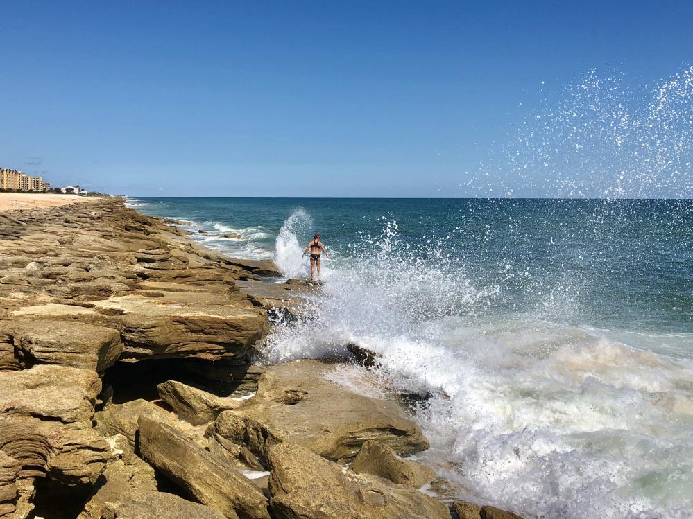 Woman standing on the beach at Washington Oaks Gardens State Park